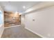 Finished basement with carpet flooring and a decorative wood accent wall at 10031 Truckee St, Commerce City, CO 80022