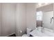 Bathroom with a single vanity, mirror, and toilet, providing a simple and functional space at 10031 Truckee St, Commerce City, CO 80022