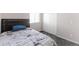 Bedroom with bed, window with blinds, carpet flooring, and a closet at 10031 Truckee St, Commerce City, CO 80022