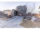 This modern home shows off a minimalist landscape and a contemporary garage door design at 10031 Truckee St, Commerce City, CO 80022