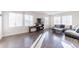 Bright living room features hardwood floors, lots of windows and cozy seating arrangements at 10031 Truckee St, Commerce City, CO 80022
