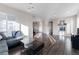 Open living space with hardwood floors, a fireplace, and a view of the dining area and modern kitchen at 10031 Truckee St, Commerce City, CO 80022