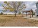 Backyard featuring a covered patio area with mature tree at 18715 Wagon Trl, Mead, CO 80542