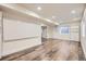 Spacious basement area with wood-look flooring, bright lighting, and ample space for activities at 18715 Wagon Trl, Mead, CO 80542