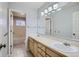 Bright bathroom with double sinks and large vanity, with access to a shower and bathtub at 18715 Wagon Trl, Mead, CO 80542