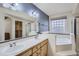 Spacious primary bathroom featuring double sink vanity, soaking tub, and shower at 18715 Wagon Trl, Mead, CO 80542