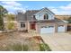 Attractive two-story brick-and-blue home with a three-car garage and well-maintained landscaping at 18715 Wagon Trl, Mead, CO 80542