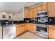 Well-equipped kitchen featuring granite countertops, stainless steel appliances, and wood cabinetry at 18715 Wagon Trl, Mead, CO 80542