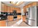 Bright kitchen with tile flooring, stainless steel appliances, and ample cabinet space at 18715 Wagon Trl, Mead, CO 80542