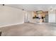 Open-concept living room leading to the kitchen featuring stainless steel appliances and a breakfast bar at 18715 Wagon Trl, Mead, CO 80542