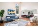 Open living and dining area with hardwood floors and coordinated modern furnishings at 18715 Wagon Trl, Mead, CO 80542
