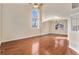Bright and airy living area with gleaming wood floors and large arched windows at 18715 Wagon Trl, Mead, CO 80542