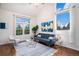 Inviting living room with a large window view and stylish contemporary furniture at 18715 Wagon Trl, Mead, CO 80542