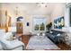 Bright living room featuring modern decor, a vaulted ceiling, and large windows at 18715 Wagon Trl, Mead, CO 80542