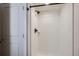 Modern bathroom shower showcasing a shower head with a shower caddy and a white door at 18715 Wagon Trl, Mead, CO 80542