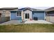 Outdoor patio with built-in grill area, lush green lawn, and secure privacy fence at 6912 Poudre St, Frederick, CO 80530