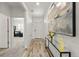 Bright entryway featuring modern decor, wood-look floors, and fresh white walls at 6912 Poudre St, Frederick, CO 80530