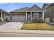 Charming single-Gathering home featuring stone accents, a two-car garage, and a welcoming front porch at 6912 Poudre St, Frederick, CO 80530