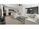 Spacious living area with comfortable seating, a modern coffee table, and an open kitchen at 6912 Poudre St, Frederick, CO 80530