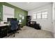 Functional home office with green accent wall, a modern desk and ample natural light at 6912 Poudre St, Frederick, CO 80530