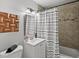 Updated bathroom with tiled shower, modern vanity and light fixtures, and a clean, fresh look at 1385 S Newton St, Denver, CO 80219