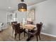 Dining area with a wood table, leather chairs, and stylish overhead lighting at 1385 S Newton St, Denver, CO 80219