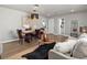 Open-concept living room with a dining table, a sitting area, and bright natural light at 1385 S Newton St, Denver, CO 80219