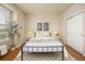 Cozy bedroom with a large window, neutral walls, and hardwood floors at 6013 Castlegate W Dr # D14, Castle Rock, CO 80108