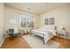 Bedroom with large window, neutral tones, hardwood floors, and plenty of natural light at 6013 Castlegate W Dr # D14, Castle Rock, CO 80108