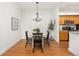 Dining area featuring a modern chandelier, hardwood floors, and views of the kitchen at 6013 Castlegate W Dr # D14, Castle Rock, CO 80108