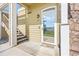 Condo entrance featuring a glass door and access to a staircase, unit number D14 at 6013 Castlegate W Dr # D14, Castle Rock, CO 80108