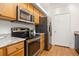 The kitchen has stainless steel appliances and wooden cabinets for lots of storage space at 6013 Castlegate W Dr # D14, Castle Rock, CO 80108