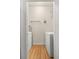 Bright laundry room with wood floors, washer, dryer, and plenty of shelving space at 6013 Castlegate W Dr # D14, Castle Rock, CO 80108