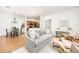 Open-concept living room with a hardwood floor, a kitchen view, and a dining area at 6013 Castlegate W Dr # D14, Castle Rock, CO 80108