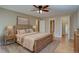 Serene bedroom featuring a wooden bed frame, soft lighting, hardwood floors and ensuite bathroom at 6495 E Happy Canyon Rd # 22, Denver, CO 80237