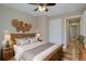 Comfortable bedroom featuring a wooden bed frame, ceiling fan, and woven wall decorations at 6495 E Happy Canyon Rd # 22, Denver, CO 80237