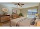 Comfortable bedroom with neutral tones, wood furnishings, and a large window for ample natural light at 6495 E Happy Canyon Rd # 22, Denver, CO 80237