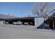 Covered carport parking area, gray building, with direct access to the homes and an asphalt surface at 6495 E Happy Canyon Rd # 22, Denver, CO 80237