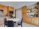 Cozy dining area with a round table, stylish chairs, built-in cabinets and display shelves at 6495 E Happy Canyon Rd # 22, Denver, CO 80237