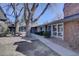 Charming exterior view of a home with mature trees, well-maintained landscaping, and walkway to the front door at 6495 E Happy Canyon Rd # 22, Denver, CO 80237