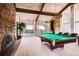 Game room with a pool table, brick fireplace and a view of the swimming pool at 6495 E Happy Canyon Rd # 22, Denver, CO 80237