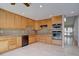 Well-lit kitchen showcasing custom cabinets, stainless steel appliances, tile backsplash and tile flooring at 6495 E Happy Canyon Rd # 22, Denver, CO 80237