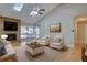 Inviting living room featuring a fireplace, hardwood floors, high ceilings with skylights, and ample natural light at 6495 E Happy Canyon Rd # 22, Denver, CO 80237