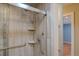 Tiled walk-in shower featuring a mounted showerhead and a built-in shelving unit at 6495 E Happy Canyon Rd # 22, Denver, CO 80237