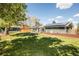 Lovely backyard view with a lush lawn, garden beds and solar panels on the roof at 863 S Dudley St, Lakewood, CO 80226