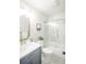 Bathroom with marble tiling, brass hardware, shower, and vanity at 863 S Dudley St, Lakewood, CO 80226