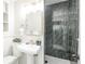Bathroom with pedestal sink and custom tiled shower at 863 S Dudley St, Lakewood, CO 80226