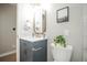 Chic bathroom featuring a blue vanity and marble countertop at 863 S Dudley St, Lakewood, CO 80226