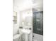This bathroom showcases stylish black tile in the shower and classic white fixtures for a clean, modern look at 863 S Dudley St, Lakewood, CO 80226