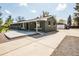 Well-maintained home with a long driveway and a detached garage at 863 S Dudley St, Lakewood, CO 80226